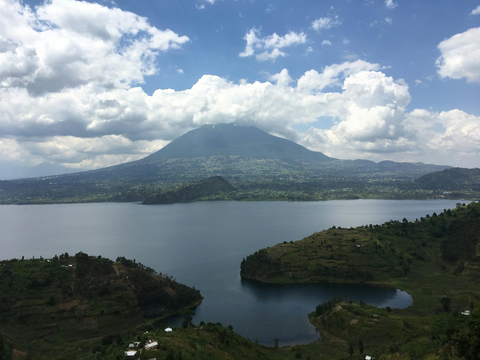 Beautiful landscape of a lake with mountains under a cloudy sky in Butaro, Rwanda. kwesttzadventures rwanda
