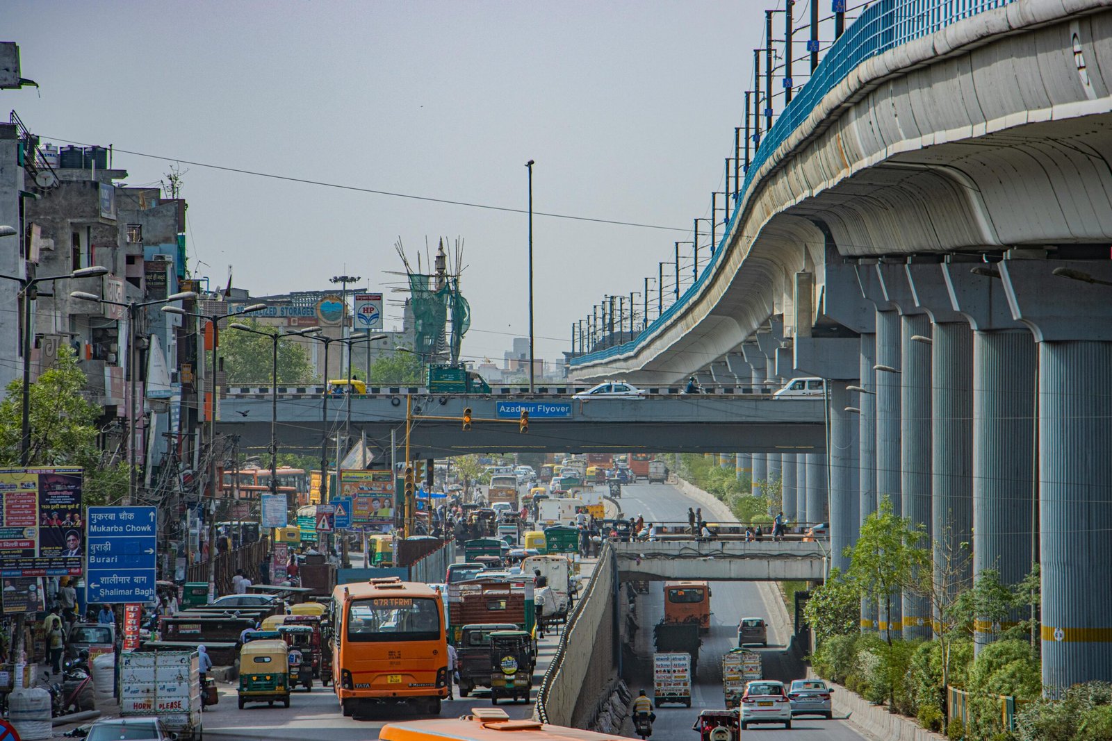 View of a busy road in Delhi featuring the Azadpur Flyover and local traffic. kwesttzsadventures delhi