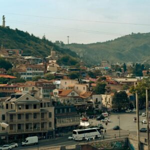 A scenic view of Tbilisi, Georgia, showcasing historic architecture and cable car over the city. kwesttzadventure georgia